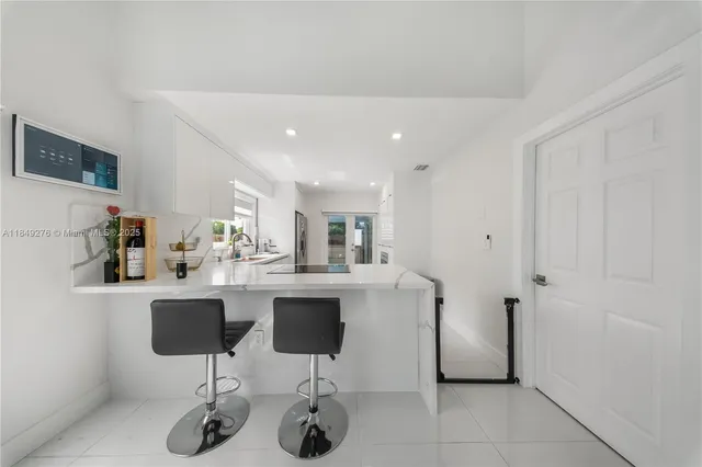 a kitchen with stainless steel appliances kitchen island a chandelier