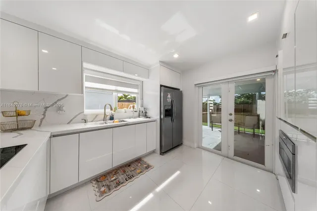 a kitchen with sink and refrigerator