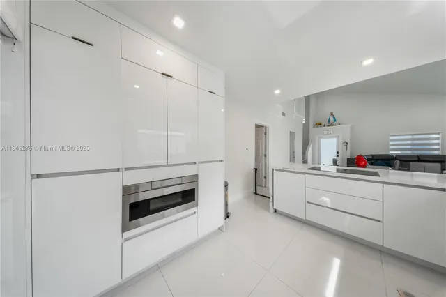 a kitchen with sink cabinets and microwave