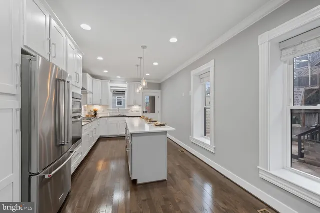 a kitchen with stainless steel appliances granite countertop a refrigerator and a sink