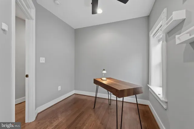 a room with a bench and wooden floor