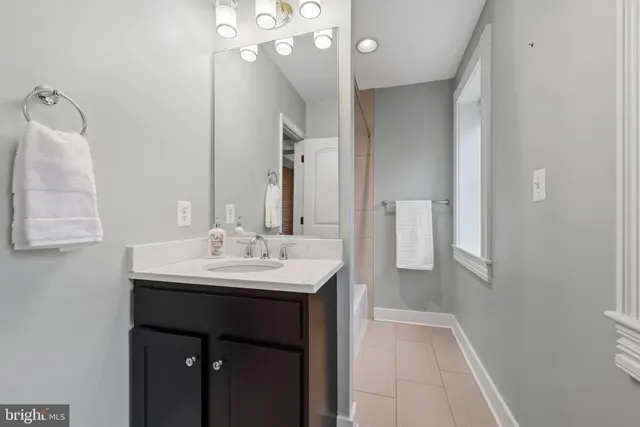 a bathroom with a sink a mirror and a shower