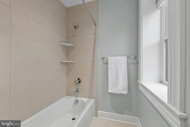 a bathroom with a bathtub and shower