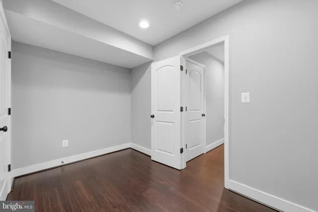 an empty room with wooden floor