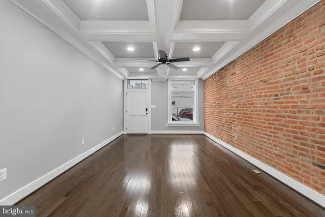a view of an empty room and wooden floor