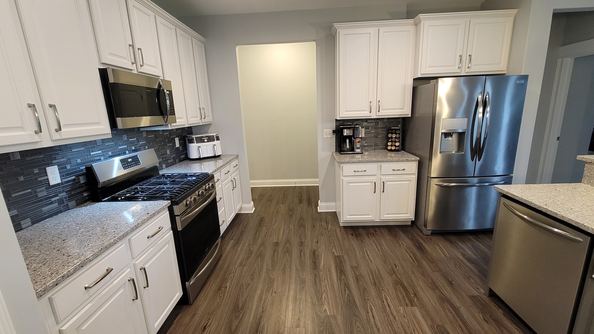 1919 Truman Street Sycamore, IL 60178 - Photo 13 of 50 a kitchen with stainless steel appliances wooden floors and wooden cabinets