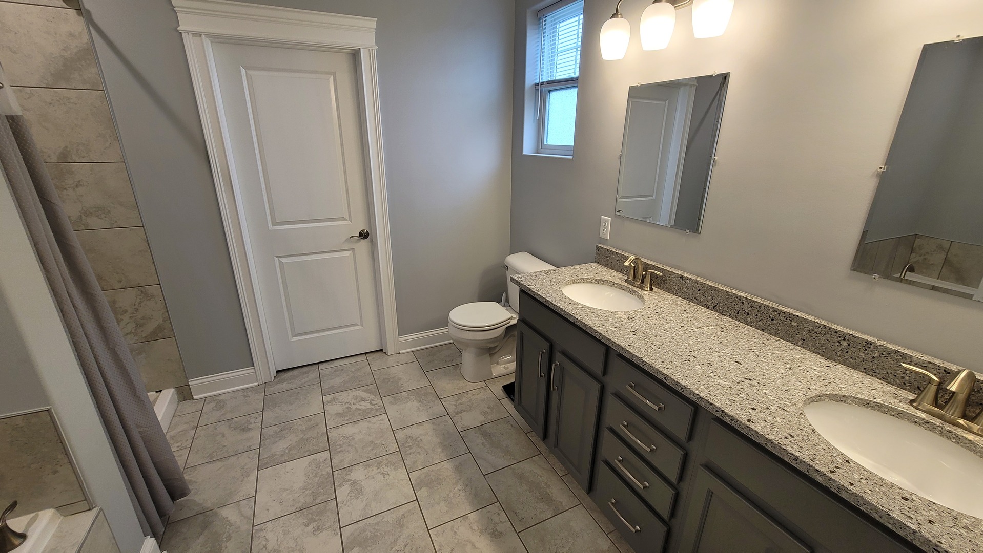 1919 Truman Street Sycamore, IL 60178 - Photo 18 of 50 a bathroom with a granite countertop sink toilet and mirror