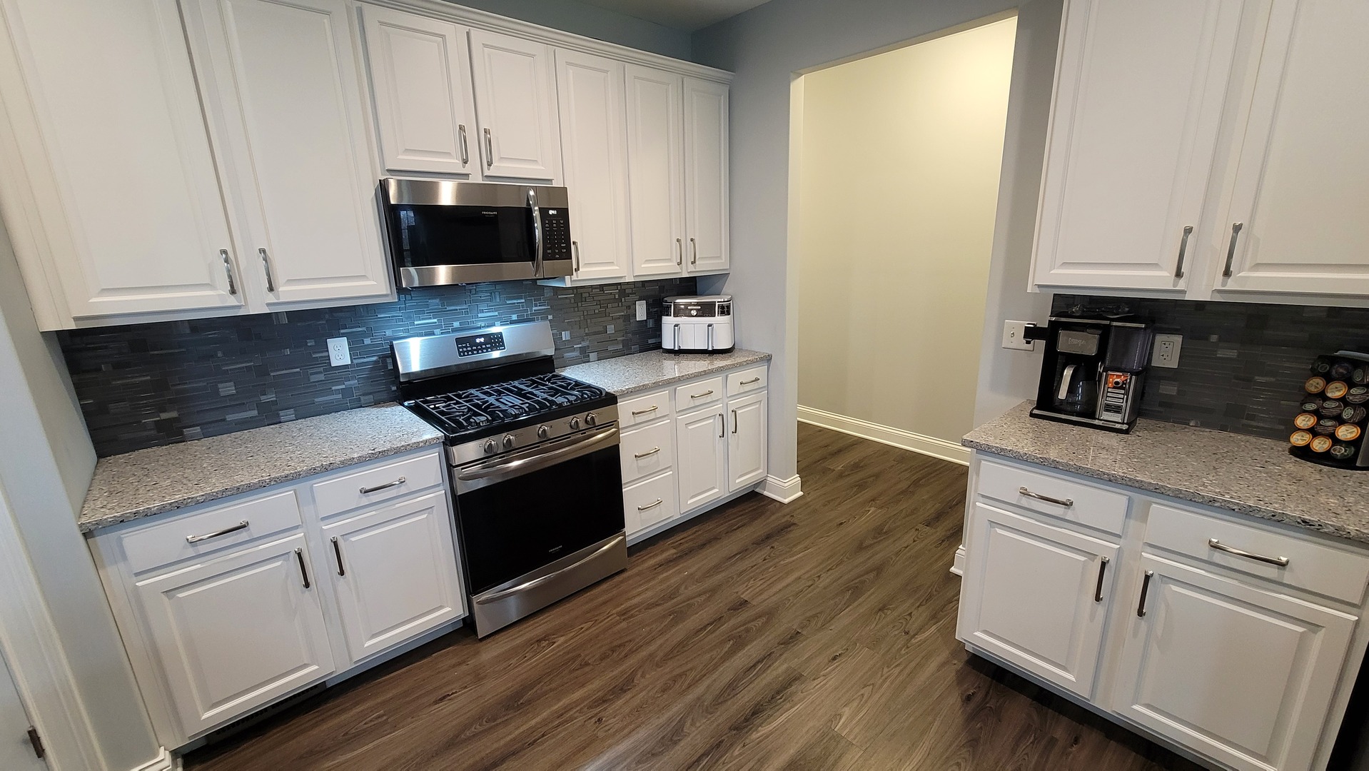 1919 Truman Street Sycamore, IL 60178 - Photo 24 of 50 a kitchen with white cabinets and black appliances