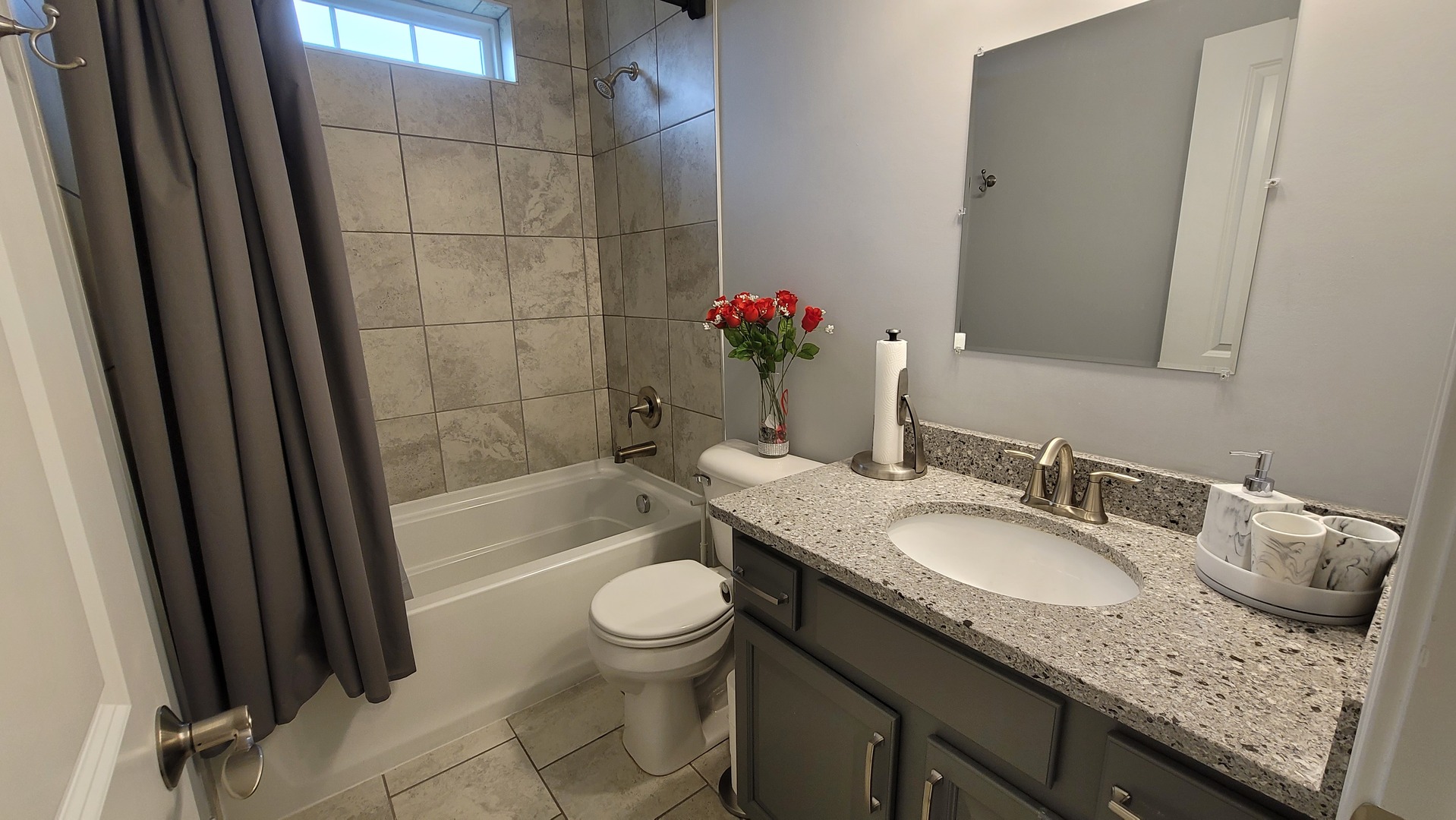 1919 Truman Street Sycamore, IL 60178 - Photo 35 of 50 a bathroom with a granite countertop sink a toilet a mirror and shower