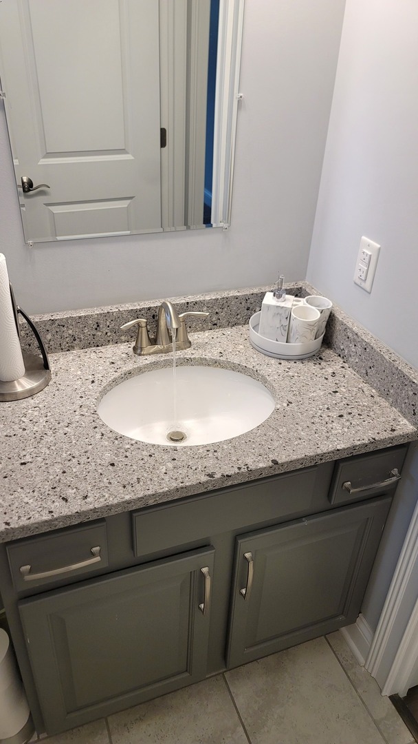 1919 Truman Street Sycamore, IL 60178 - Photo 37 of 50 a bathroom with a granite countertop sink and a mirror