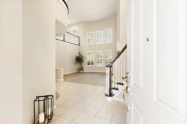 a view of a room with wooden floor and chandelier