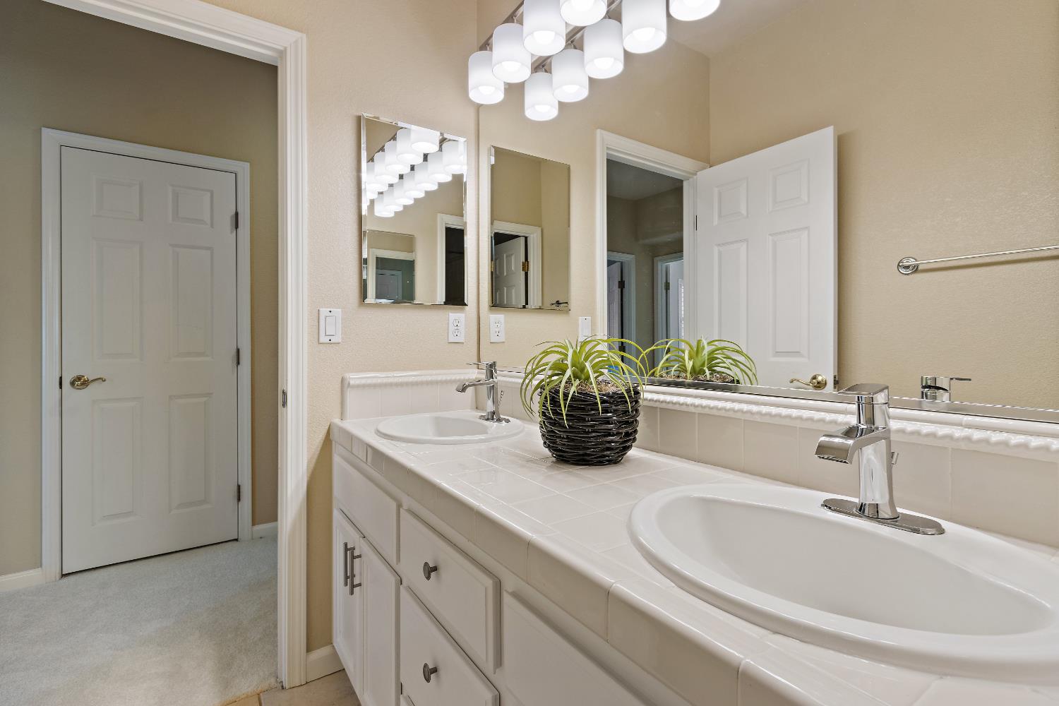 5631 Tufts Street Davis, CA 95618 - Photo 45 of 69 a bathroom with a sink double vanity and a mirror