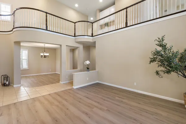 an empty room with windows and a fireplace