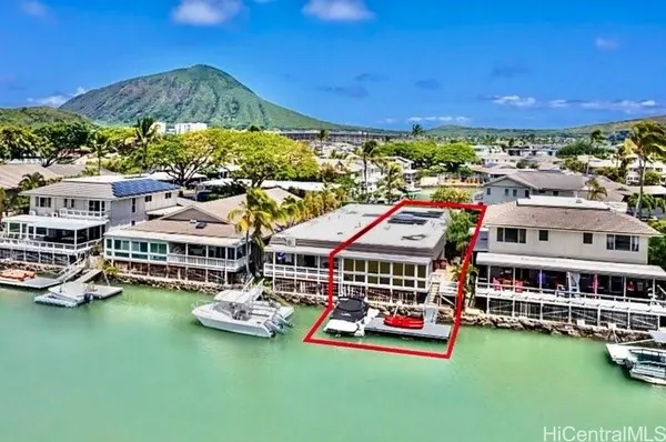 a view of a city with tall buildings and ocean view