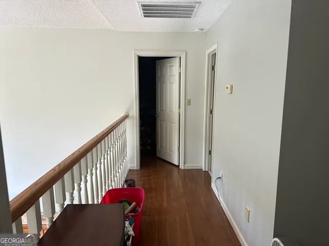 a view of hallway with wooden floor