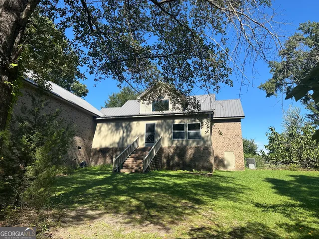a front view of house with a garden