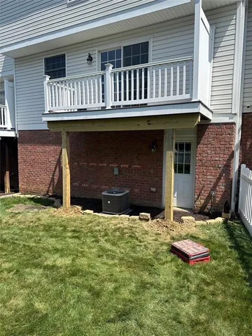 a backyard of a house with yard and outdoor seating