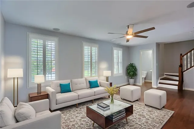 a living room with furniture a rug and a chandelier