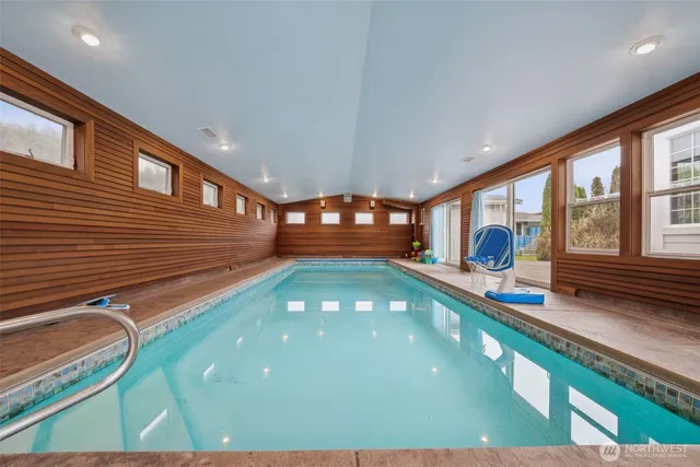 a room with pool table and windows
