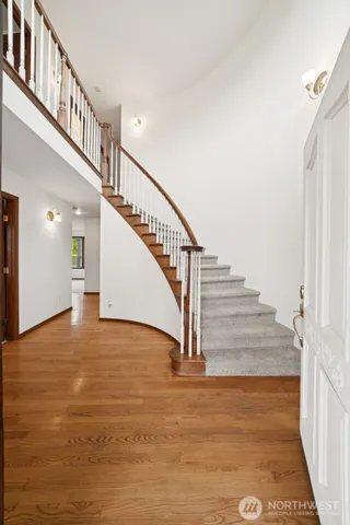 a view of entryway and hall with wooden floor