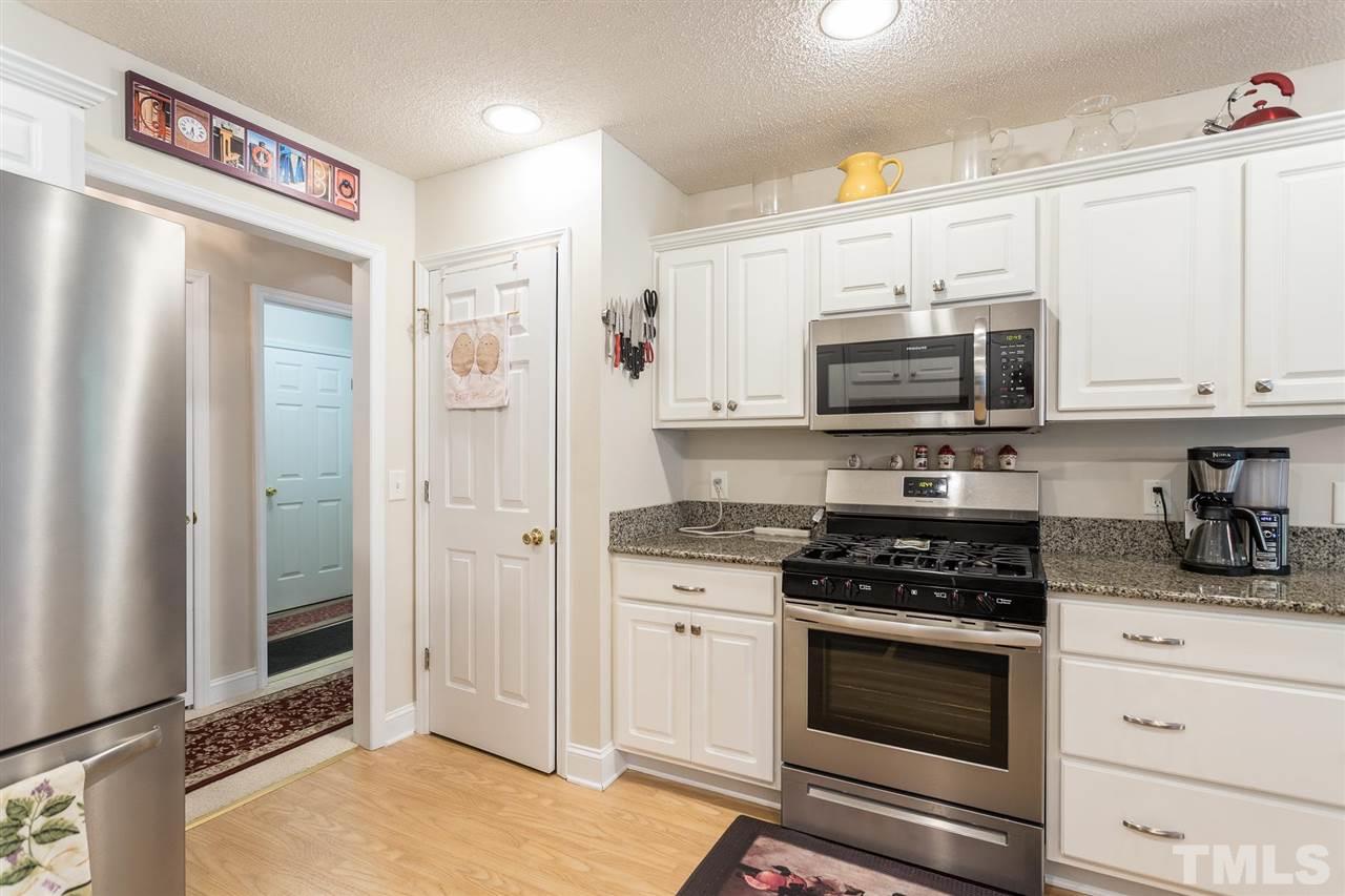 51 Hunters Lane Timberlake, NC 27583 - Photo 11 of 30 a kitchen with stainless steel appliances a stove a microwave and cabinets