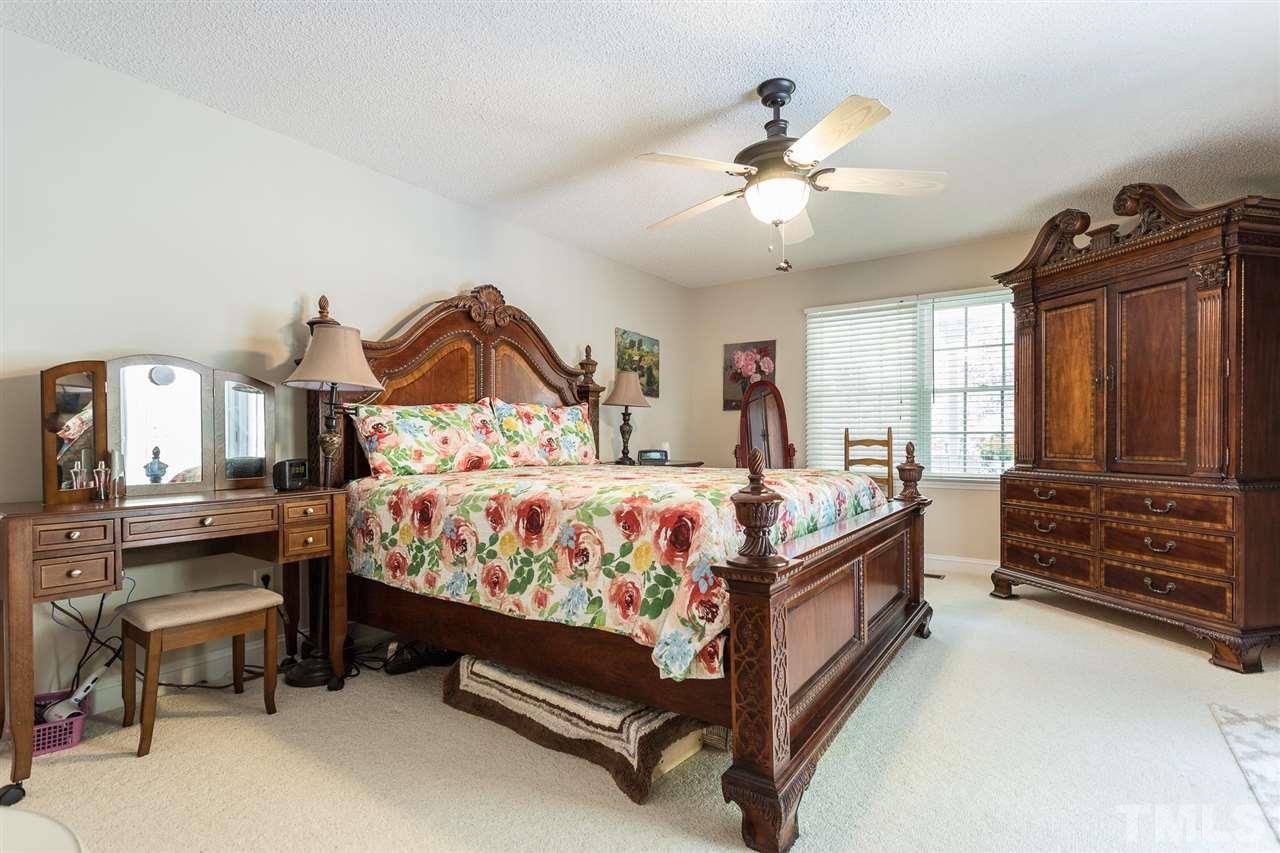 51 Hunters Lane Timberlake, NC 27583 - Photo 15 of 30 a bed room with a bed and a chandelier