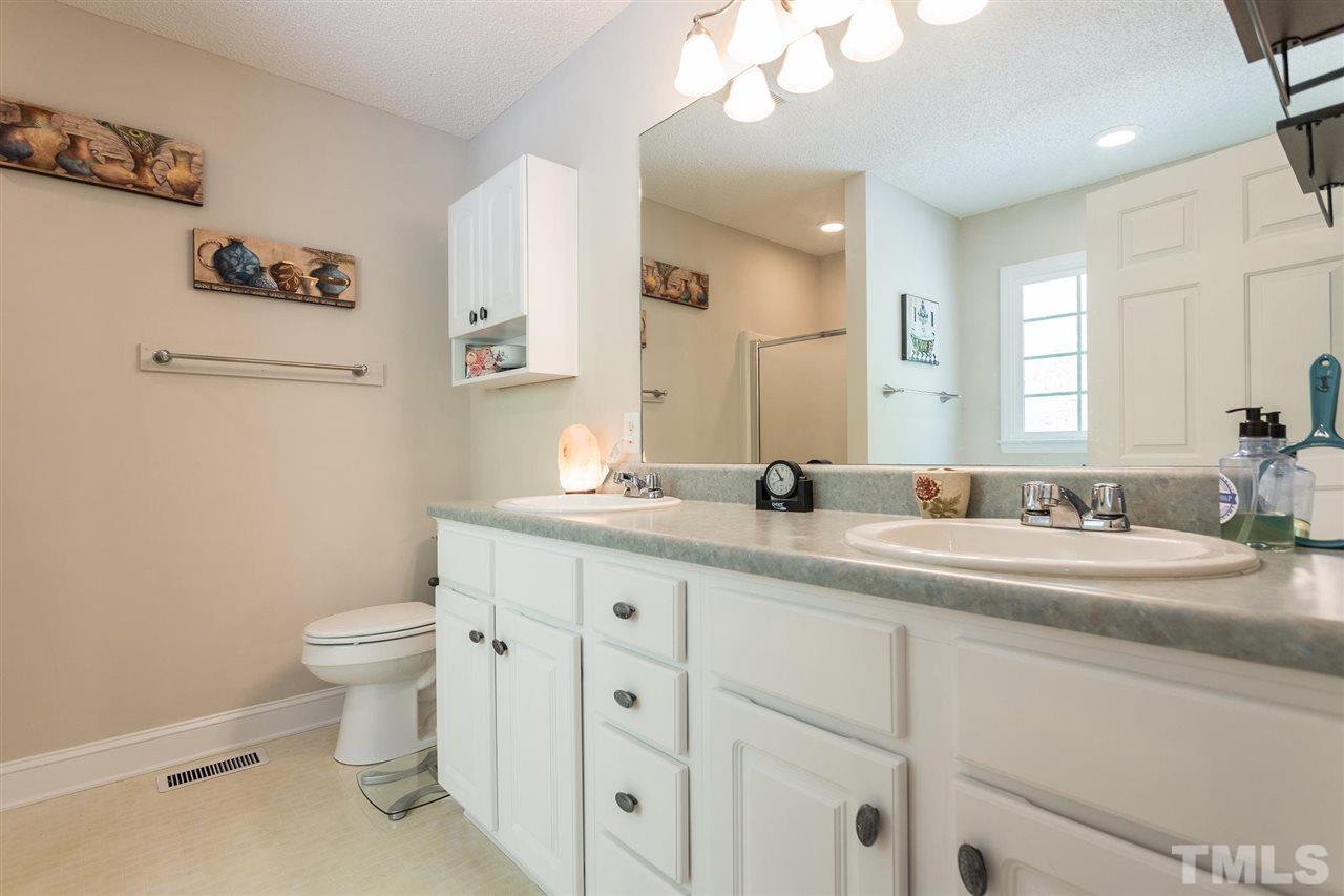 51 Hunters Lane Timberlake, NC 27583 - Photo 17 of 30 a bathroom with a granite countertop sink mirror and toilet
