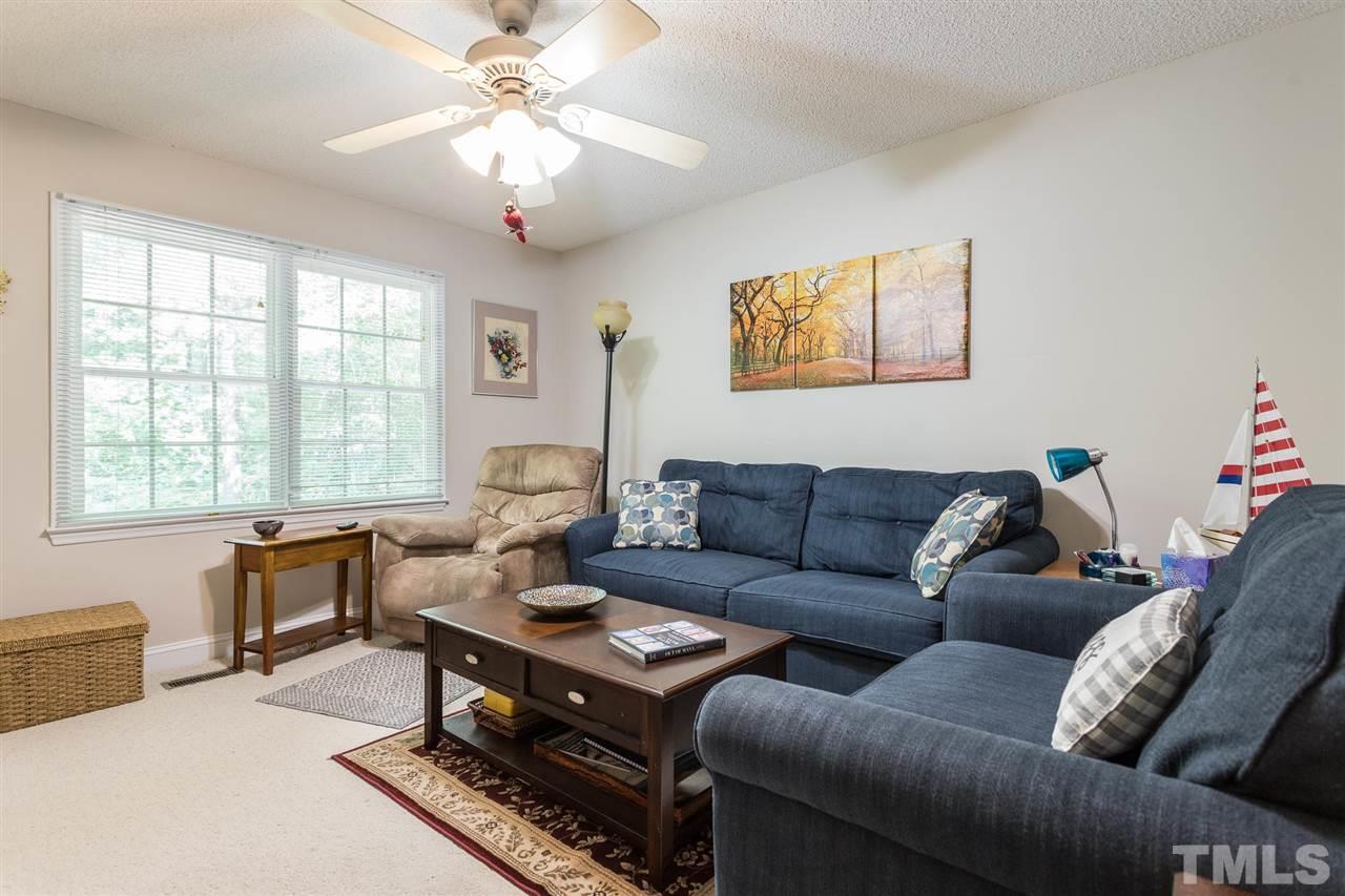 51 Hunters Lane Timberlake, NC 27583 - Photo 18 of 30 a living room with furniture a chandelier and a window
