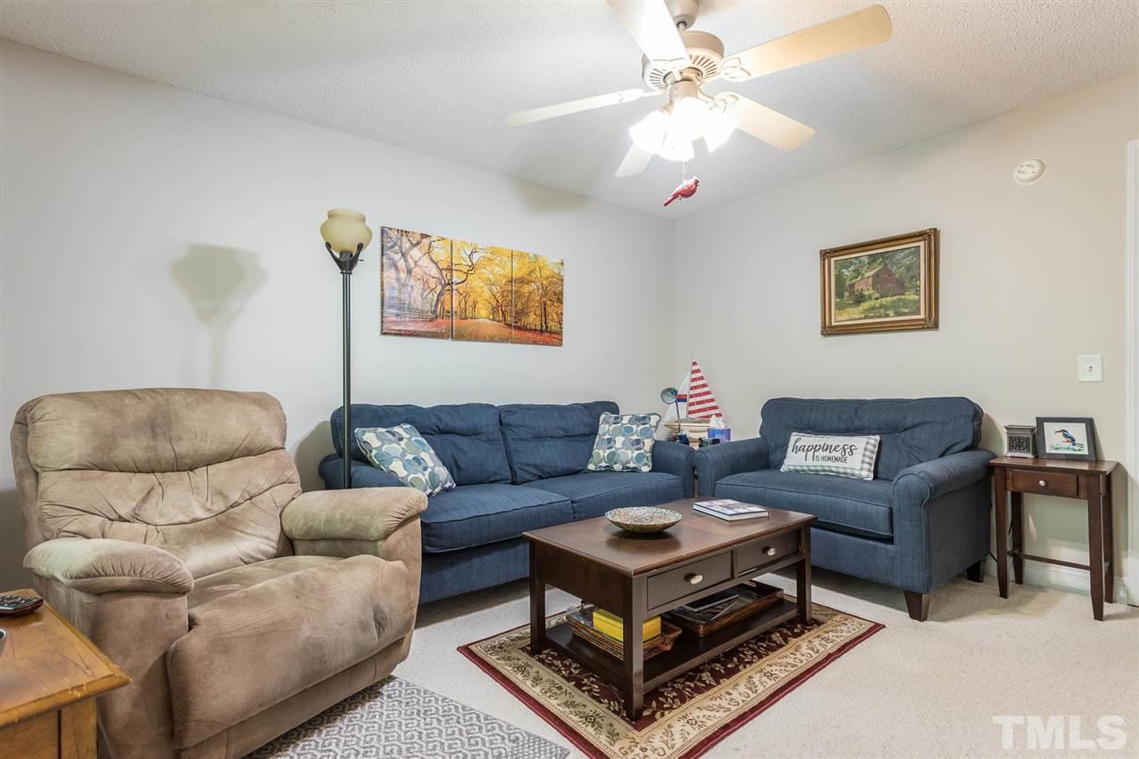 51 Hunters Lane Timberlake, NC 27583 - Photo 19 of 30 a living room with furniture and a chandelier