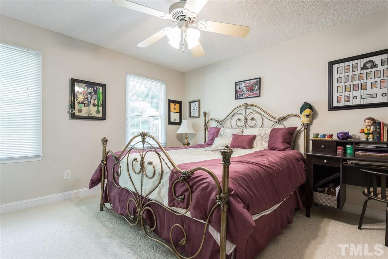 51 Hunters Lane Timberlake, NC 27583 - Photo 20 of 30 a bedroom with two beds and paintings on the wall