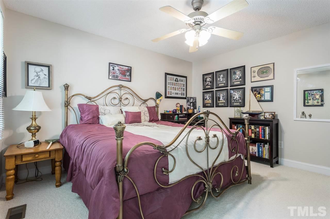 51 Hunters Lane Timberlake, NC 27583 - Photo 21 of 30 a bedroom with furniture and a chandelier