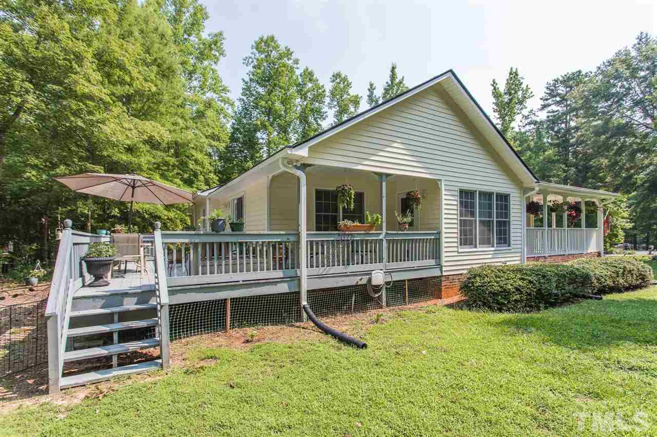 51 Hunters Lane Timberlake, NC 27583 - Photo 22 of 30 a view of house with a big yard and potted plants