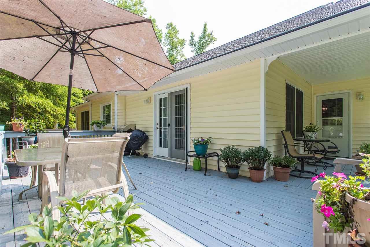 51 Hunters Lane Timberlake, NC 27583 - Photo 24 of 30 a view of a patio with table and chairs under an umbrella