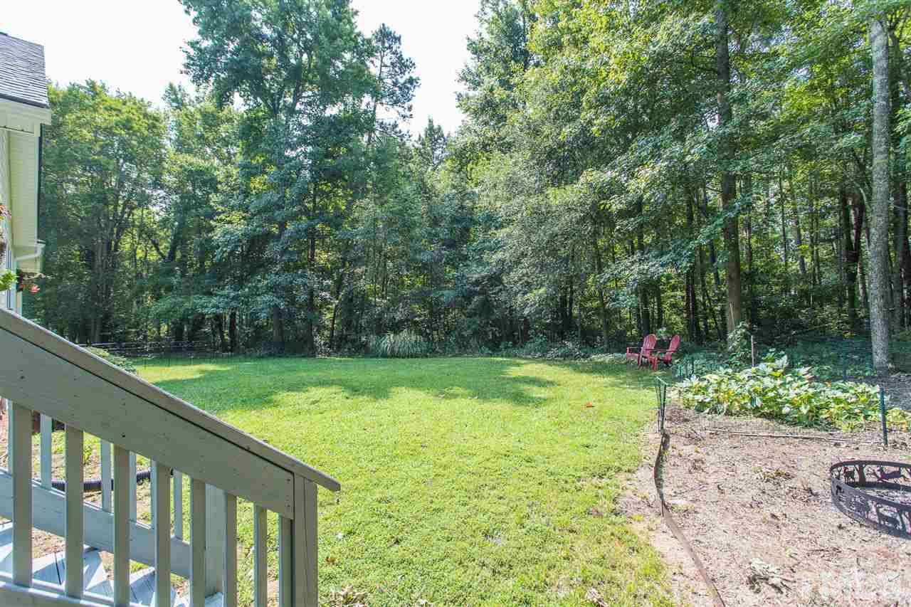 51 Hunters Lane Timberlake, NC 27583 - Photo 27 of 30 a view of a backyard with potted plants and large trees