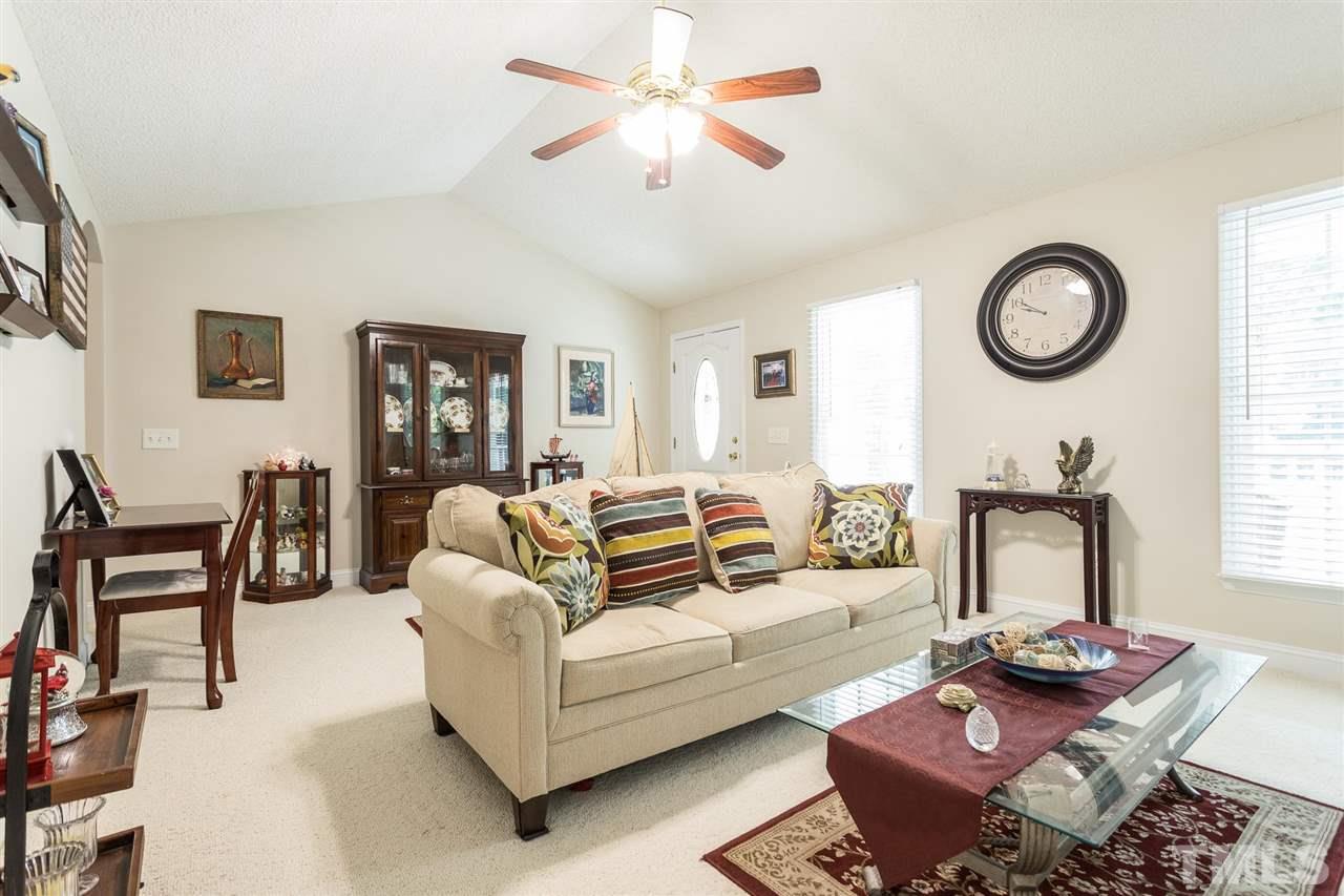 51 Hunters Lane Timberlake, NC 27583 - Photo 4 of 30 a living room with furniture a rug and a window
