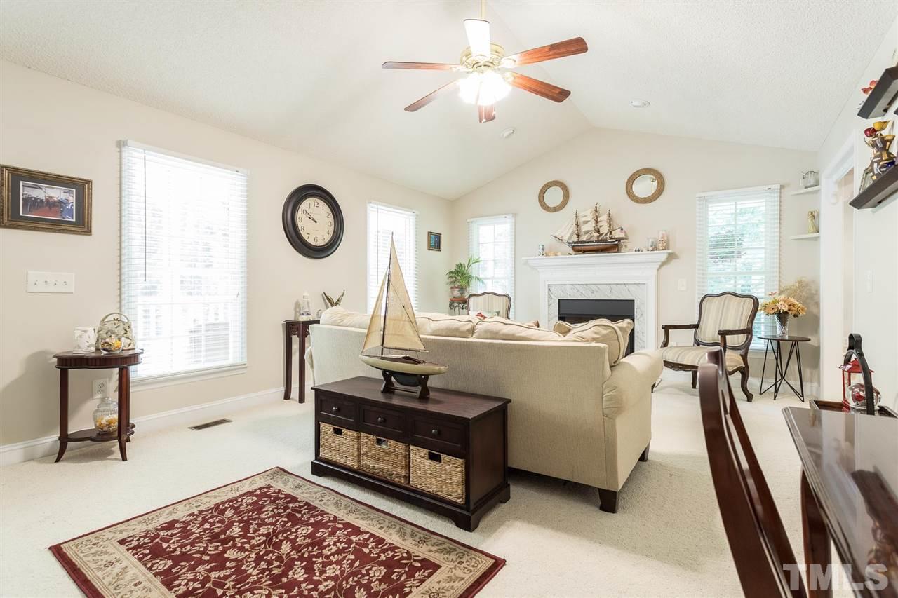 51 Hunters Lane Timberlake, NC 27583 - Photo 5 of 30 a living room with furniture a clock and a table