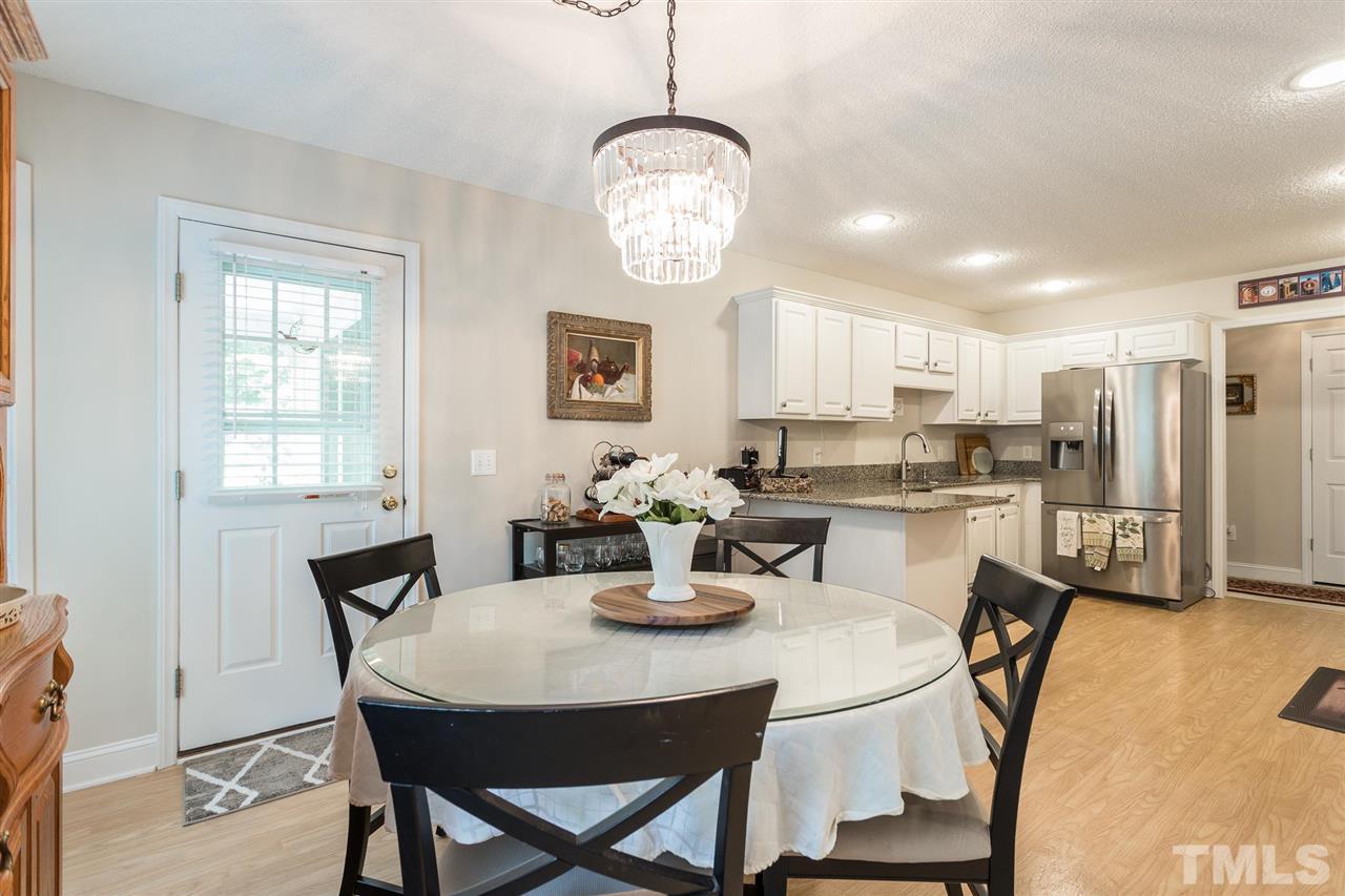 51 Hunters Lane Timberlake, NC 27583 - Photo 7 of 30 a view of a dining room with furniture window and wooden floor