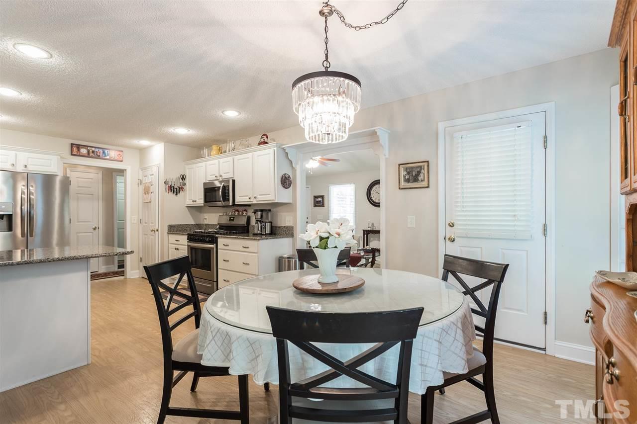 51 Hunters Lane Timberlake, NC 27583 - Photo 8 of 30 a view of a dining room with furniture and wooden floor