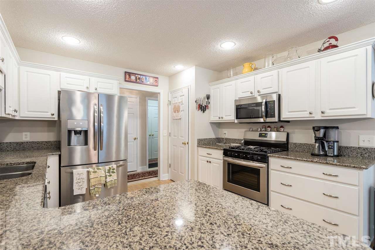 51 Hunters Lane Timberlake, NC 27583 - Photo 9 of 30 a kitchen with stainless steel appliances granite countertop a refrigerator sink and stove