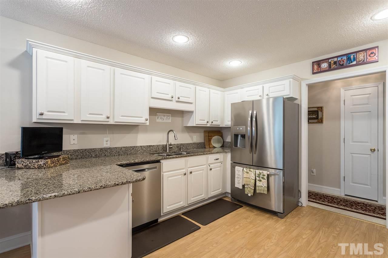 51 Hunters Lane Timberlake, NC 27583 - Photo 10 of 30 a kitchen with stainless steel appliances granite countertop a refrigerator sink and cabinets