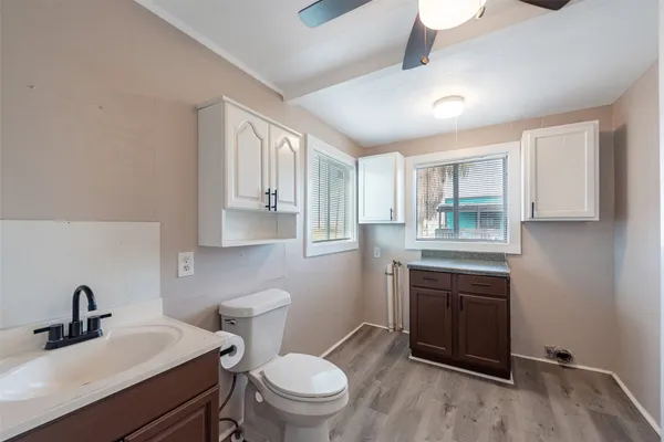 a bathroom with a sink toilet and mirror