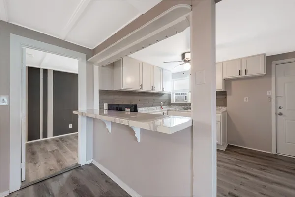 a kitchen with stainless steel appliances granite countertop a refrigerator a sink and a stove