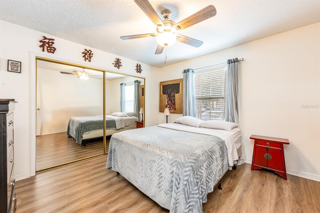 954 Forest Ridge Court, Unit 106 Lake Mary, FL 32746 - Photo 12 of 20 a spacious bedroom with a bed and a large window