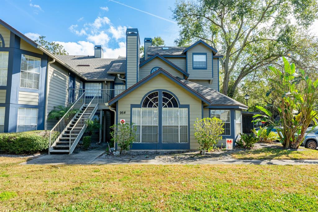 954 Forest Ridge Court, Unit 106 Lake Mary, FL 32746 - Photo 16 of 20 a front view of a house with a yard