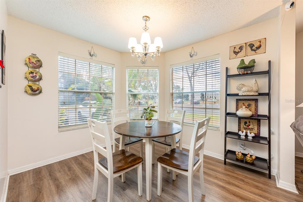 954 Forest Ridge Court, Unit 106 Lake Mary, FL 32746 - Photo 5 of 20 a dining room with furniture a chandelier and window