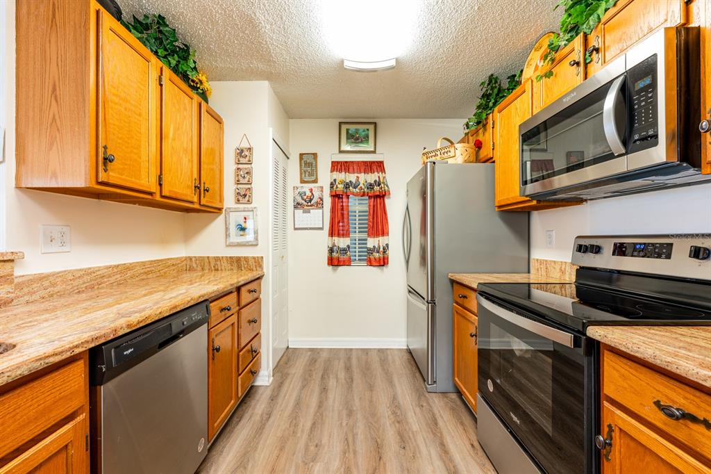 954 Forest Ridge Court, Unit 106 Lake Mary, FL 32746 - Photo 7 of 20 a kitchen with stainless steel appliances granite countertop a refrigerator a stove top oven a sink and dishwasher