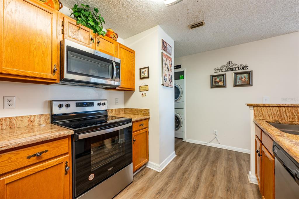 954 Forest Ridge Court, Unit 106 Lake Mary, FL 32746 - Photo 8 of 20 a kitchen with stainless steel appliances a stove microwave and cabinets