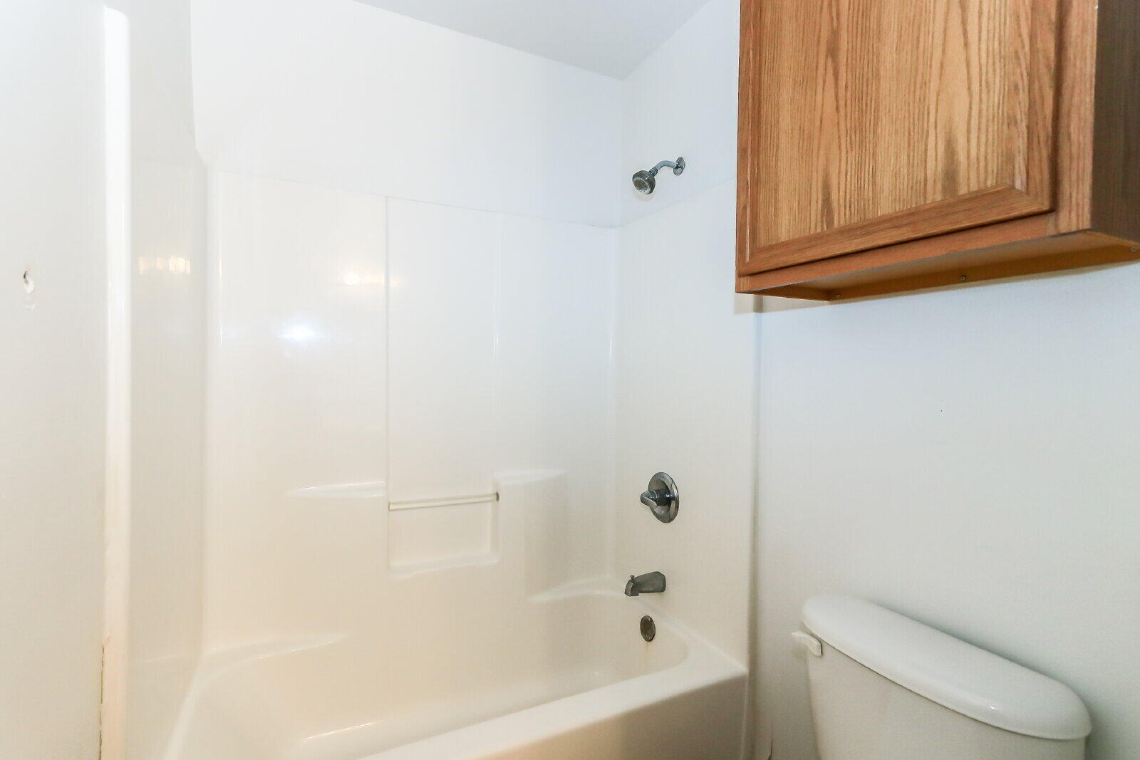 606 North Englewood Avenue, Unit A Lubbock, TX 79416 - Photo 11 of 19 a bathroom with a toilet and bathtub