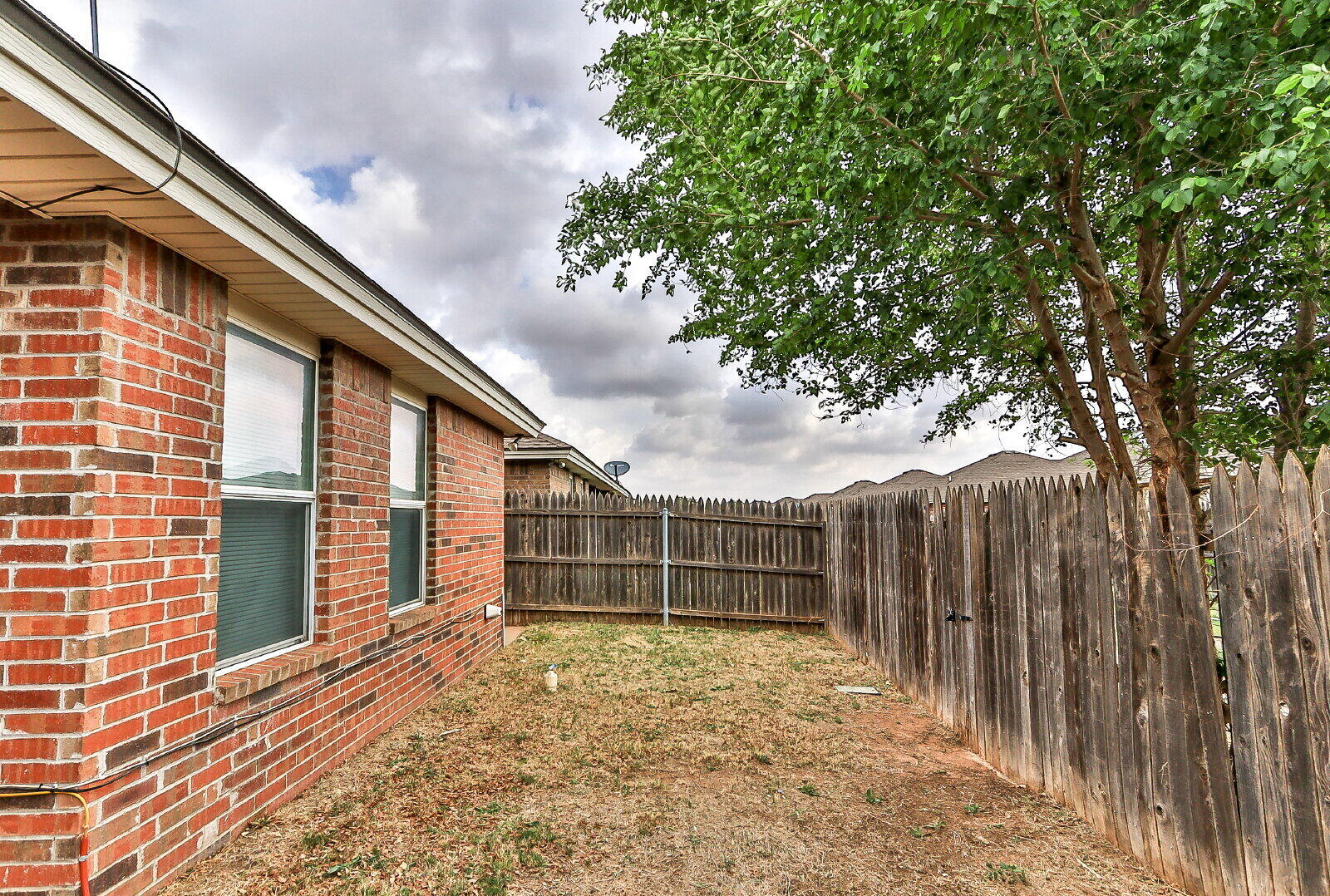 606 North Englewood Avenue, Unit A Lubbock, TX 79416 - Photo 18 of 19 a view of a house with a backyard