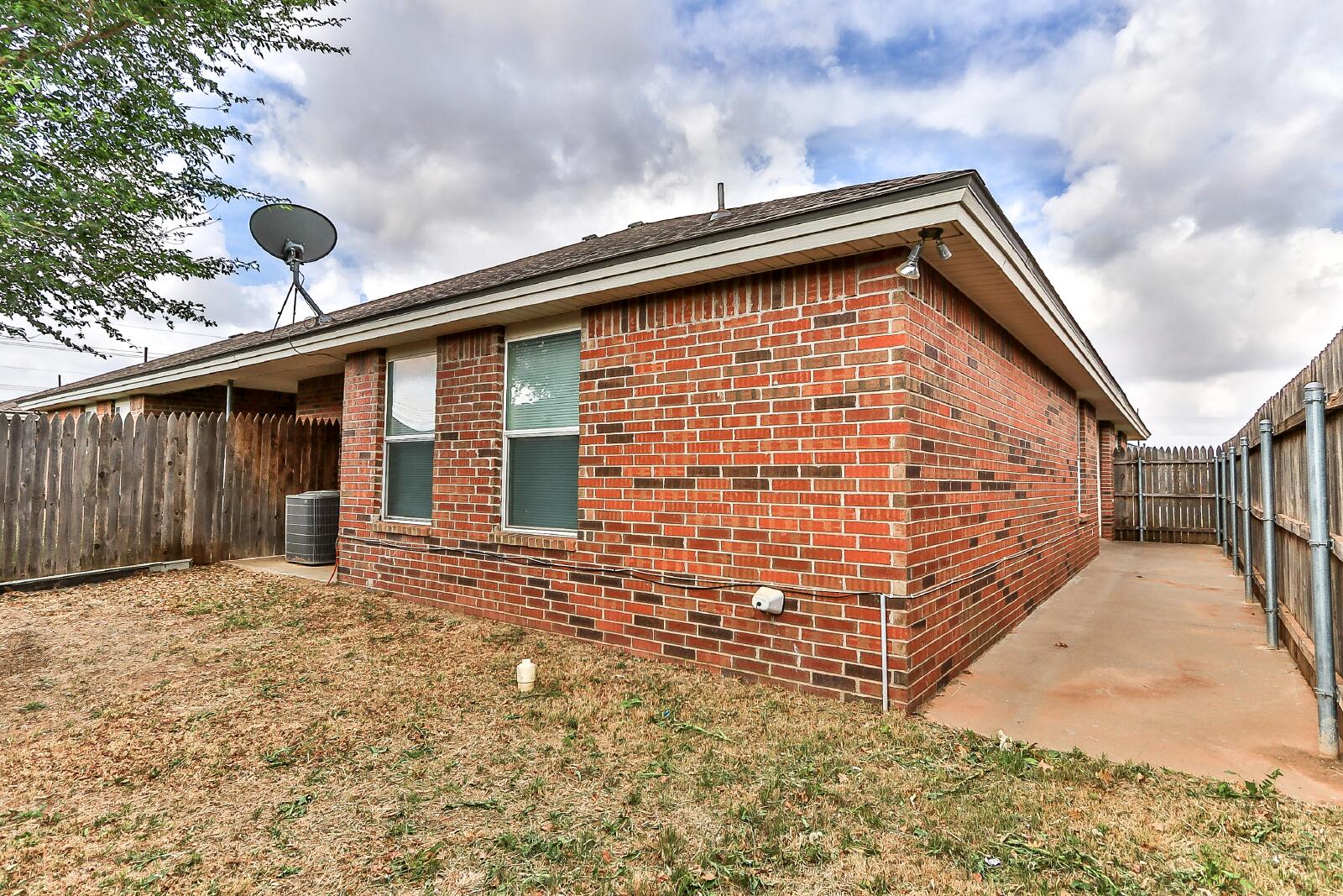 606 North Englewood Avenue, Unit A Lubbock, TX 79416 - Photo 19 of 19 a front view of a house with a yard